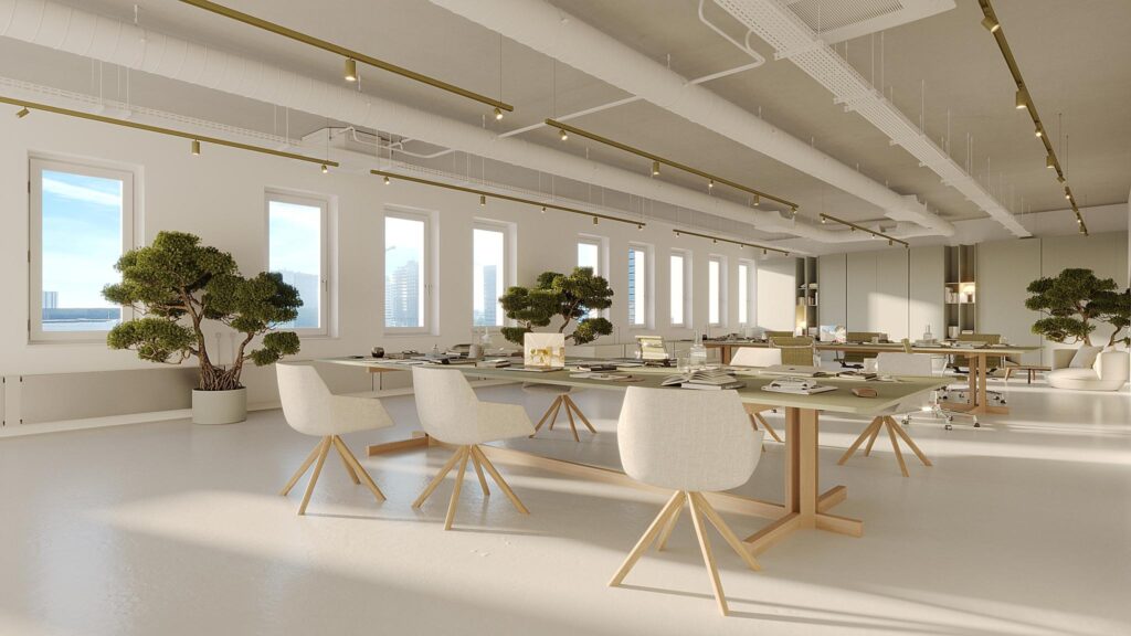Modern open-plan office on Johan Cruijff Boulevard with minimalist furniture and large potted bonsai trees.